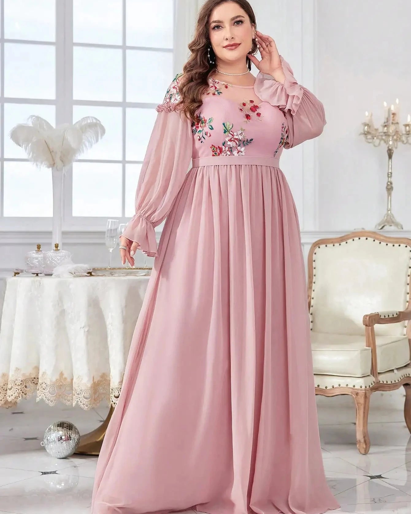 Pink chiffon evening dress with floral embroidery, long sleeves, ruffled cuffs, pleated skirt.