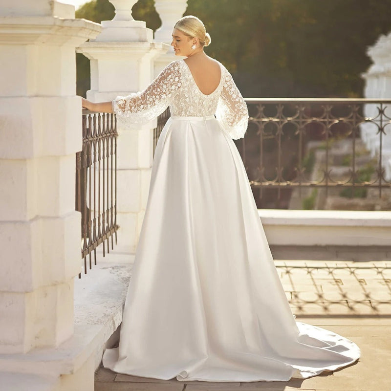 White satin wedding dress with lace long sleeves and full A-line skirt