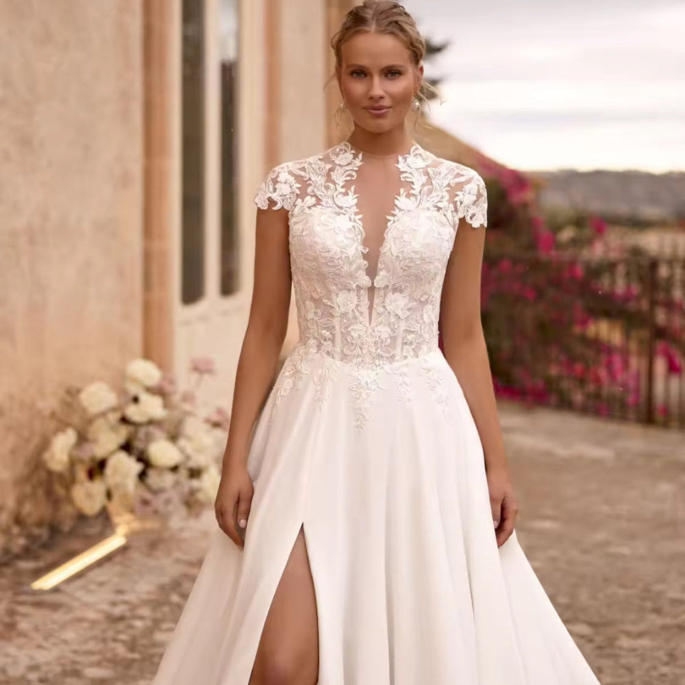 Ivory A-line wedding dress with lace V-neck bodice, short cap sleeves, front slit