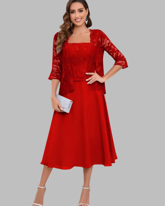 Woman wearing a red lace dress on a gray background