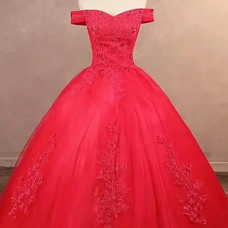 Off-shoulder lace ball gown bodice close-up with embroidered detail, bright red.