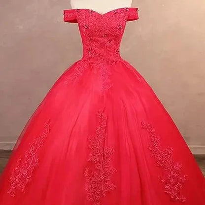 Off-shoulder lace ball gown bodice close-up with embroidered detail, bright red.