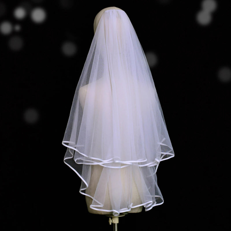 White two-tier cathedral wedding veil with satin edge finish