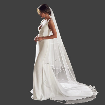 White two-tier cathedral wedding veil with sheer layers and satin trim