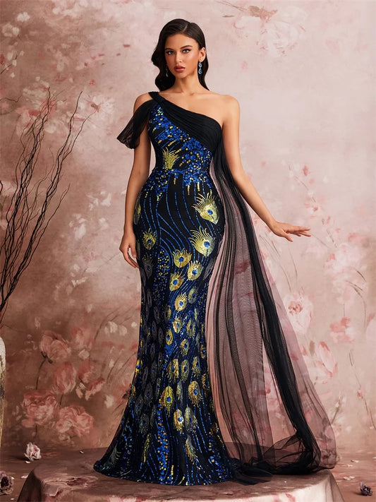 Woman wearing a one-shoulder evening gown with peacock feather design against a floral background