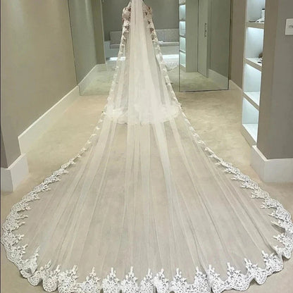 Cathedral wedding veil with sheer tulle, floral lace border along hem
