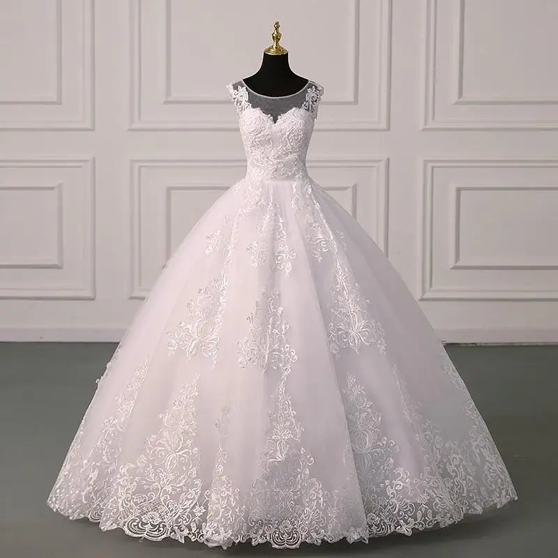 White lace sleeveless ball gown with corset bodice and voluminous embroidered skirt