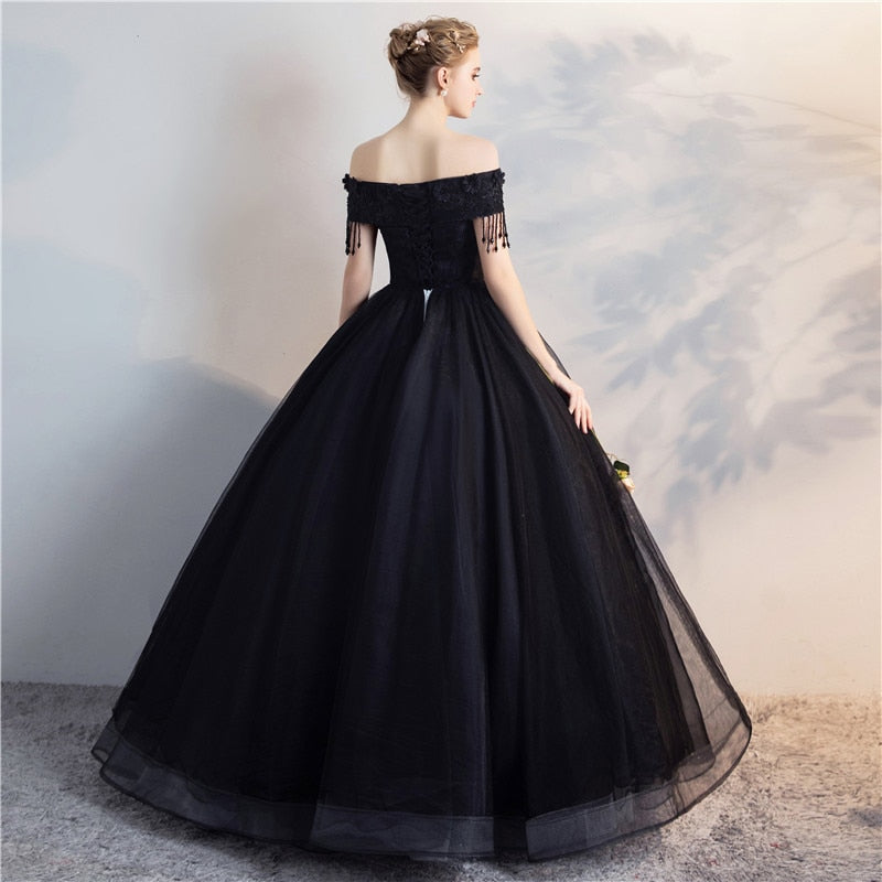 Black off-shoulder ball gown from back, lace bodice with fringe, full tulle skirt