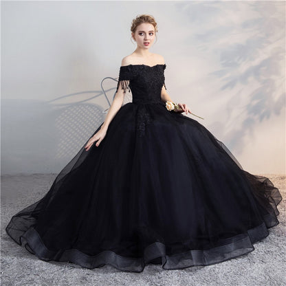 Black off-shoulder ball gown, lace top with fringe, voluminous layered tulle skirt