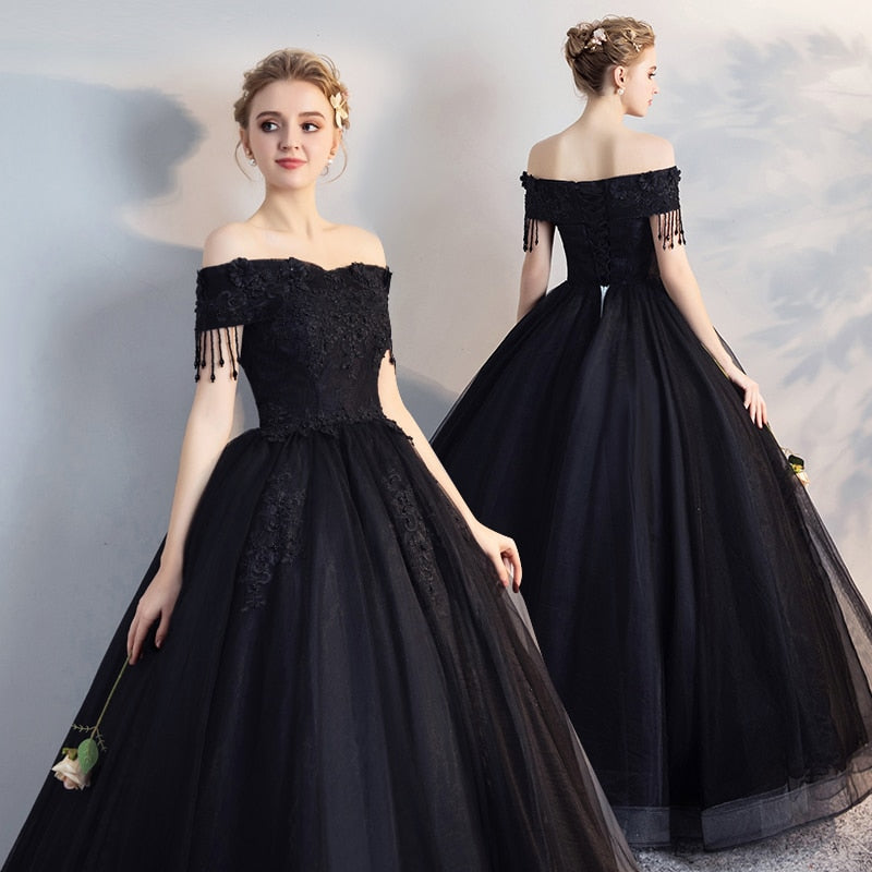 Black off-shoulder ball gown with lace bodice, fringe sleeves, full tulle skirt
