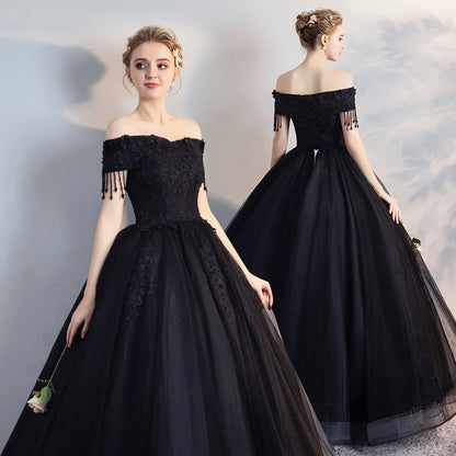 Black off-shoulder ball gown with lace bodice, fringe sleeves, full tulle skirt