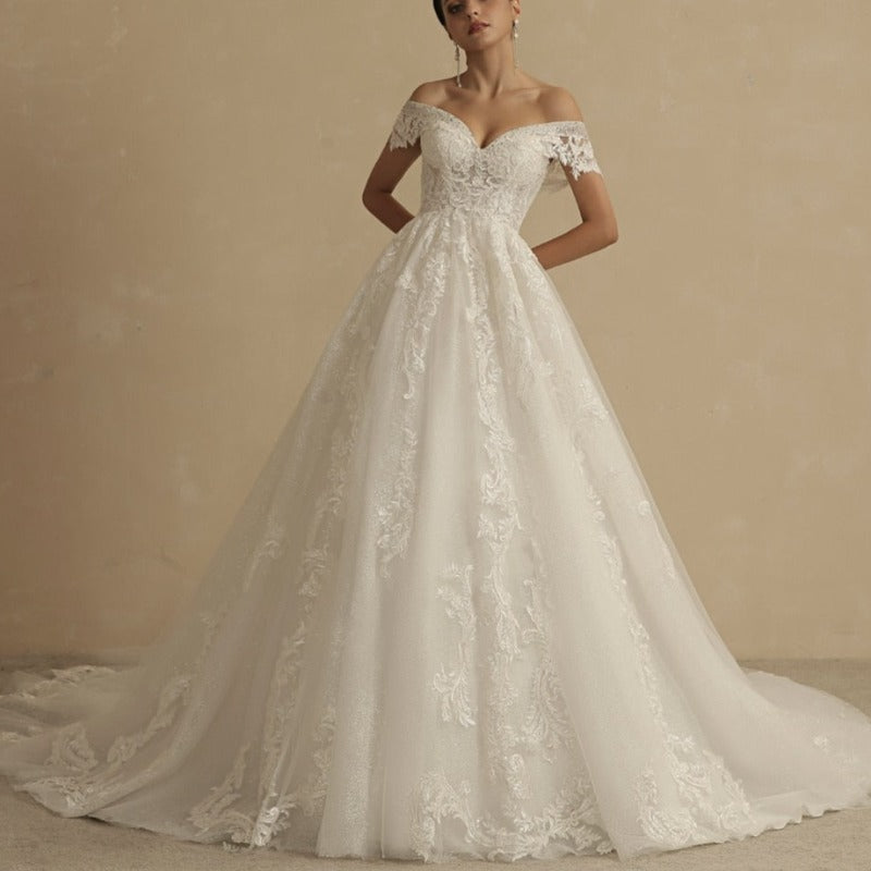 Ivory off-shoulder lace princess wedding dress with full skirt and embellished sweetheart bodice